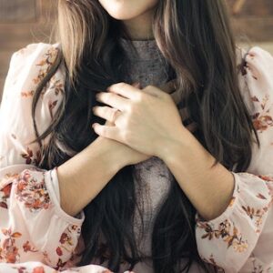 Woman with hands over heart